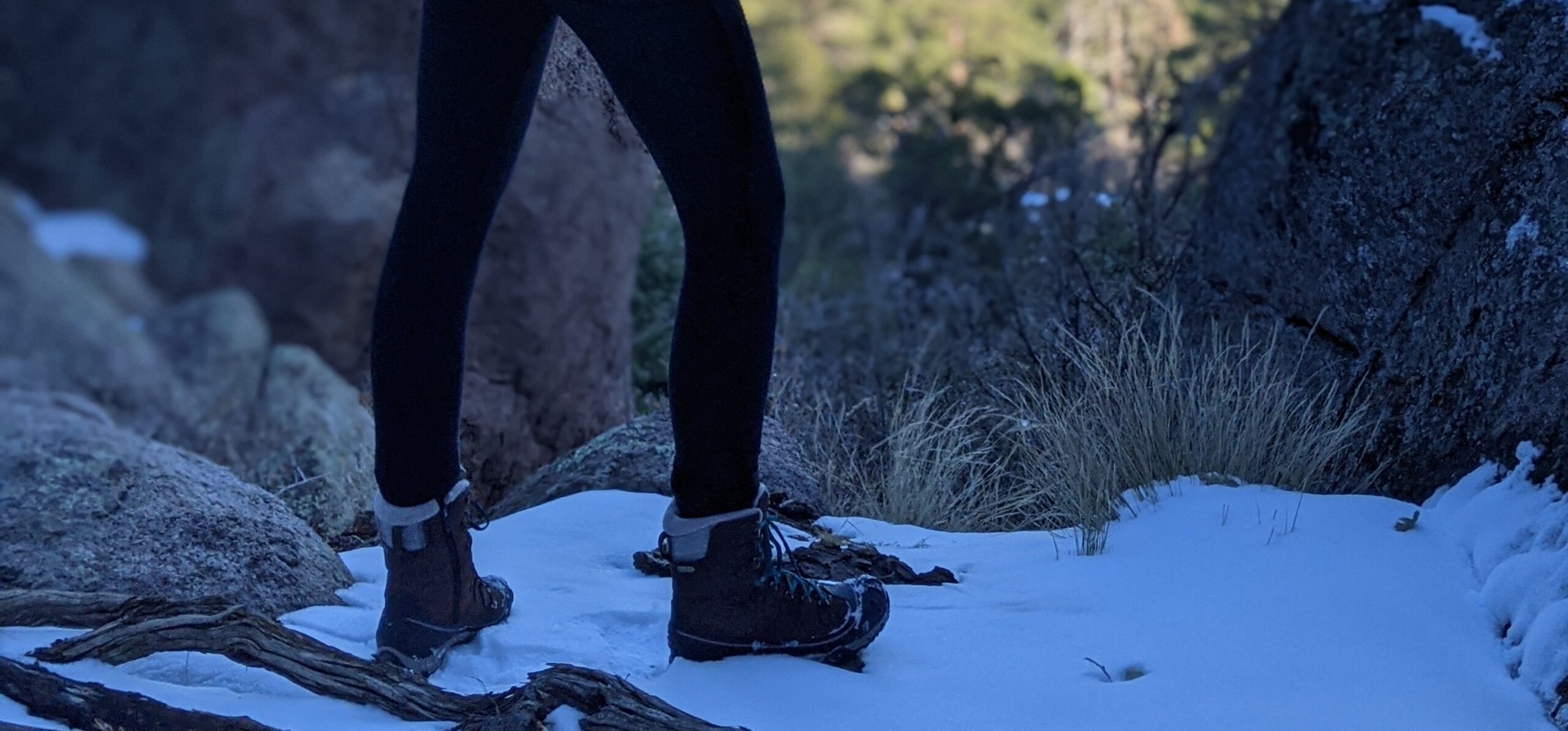 woman tying insulated hiking boots snowy trail