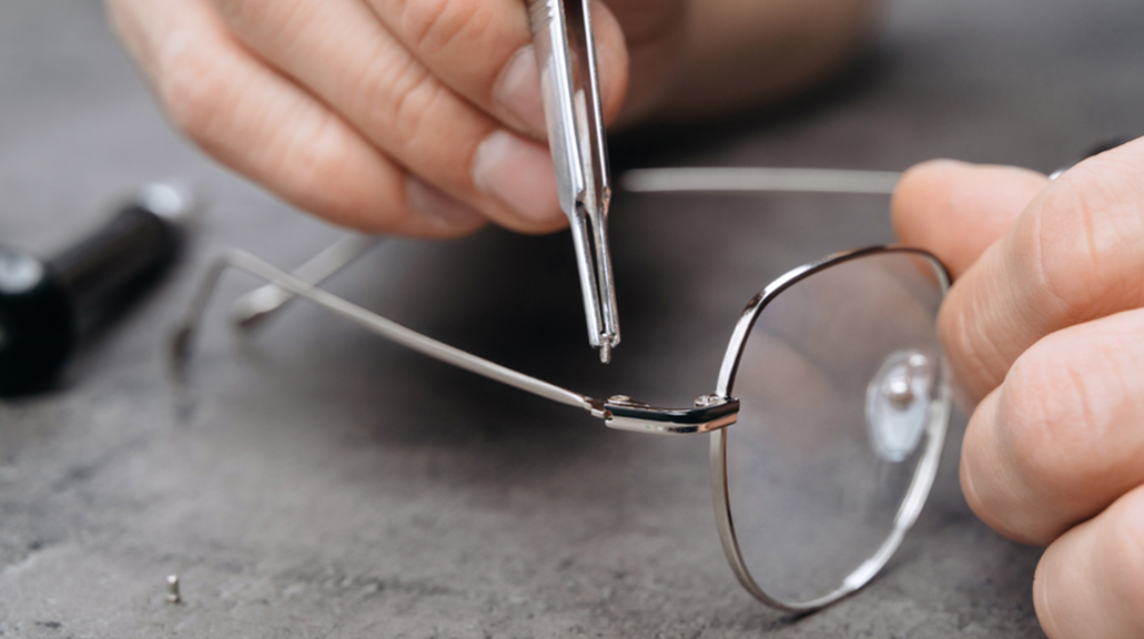 optician adjusting eyeglass frames closeup