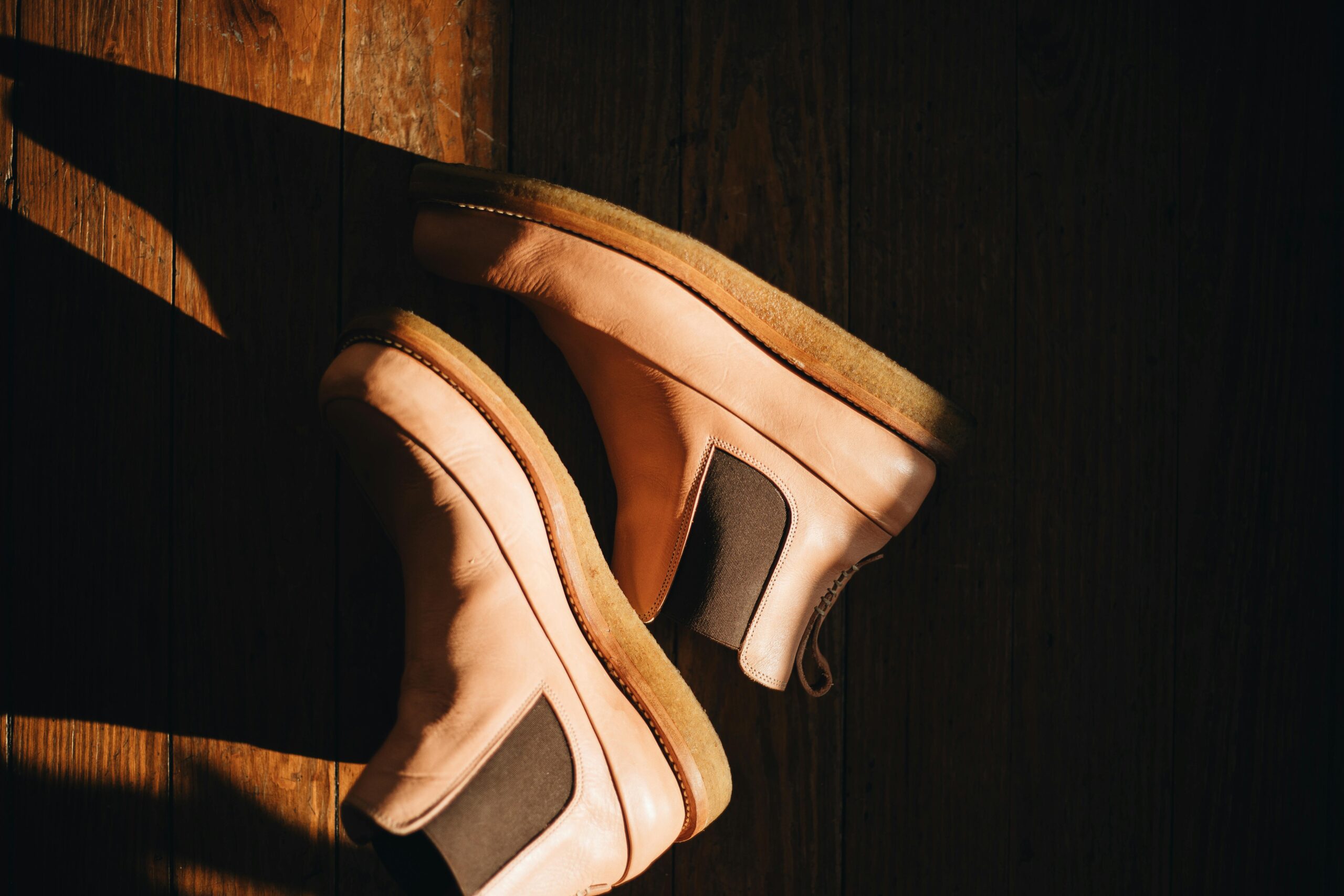 classic leather boots on wooden floor