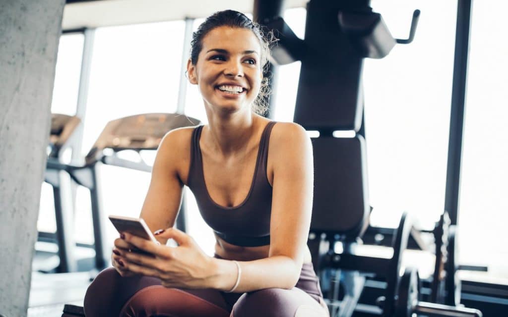 woman using fitness app gym